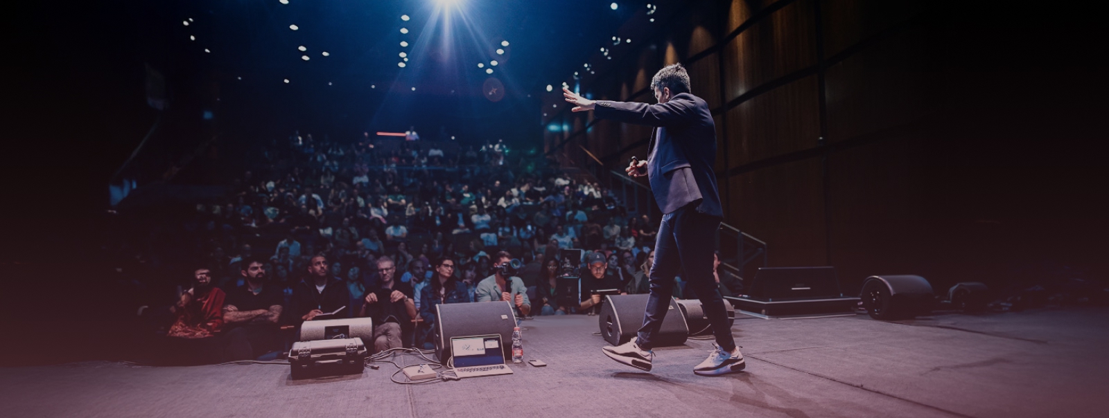 Eitan Azaria speaking on stage
